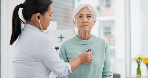 Old woman, doctor or stethoscope to check heartbeat or breathing and health of elderly patient in hospital. Consultation, listening or nurse with a senior patient for healthcare or wellness in clinic