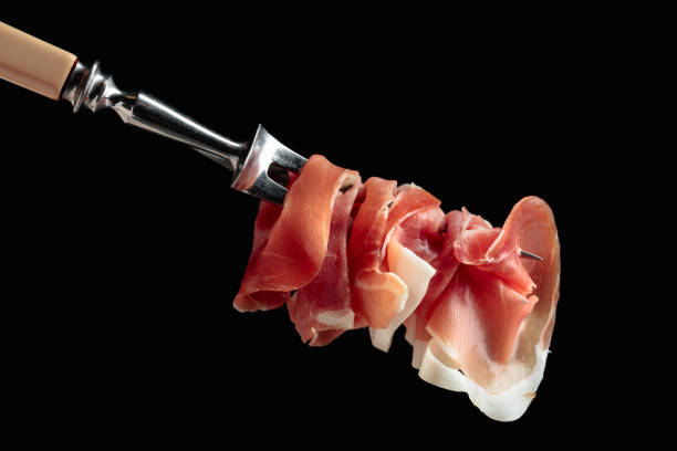 istock Slices of prosciutto on a fork. 1650854916