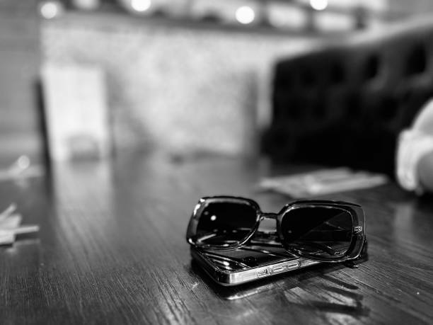 Sunglasses and a mobile phone on a restaurant table