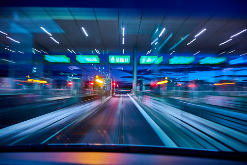 Light trails on road. High speed driving makes abstract light trails at dusk.