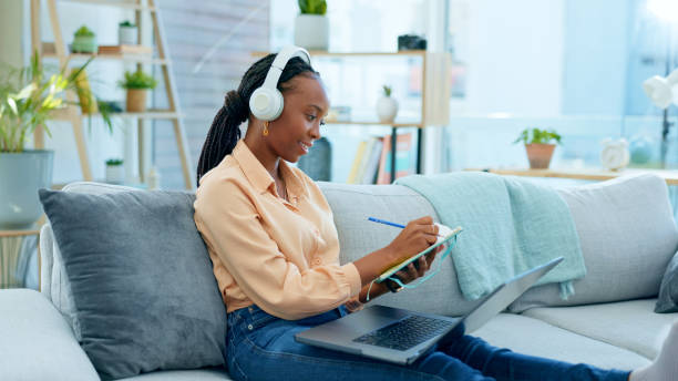 istock Black woman, laptop and video call for sofa education webinar, e learning or university presentation for living room studying. Smile, happy and talking student on technology for online college class 1650855550
