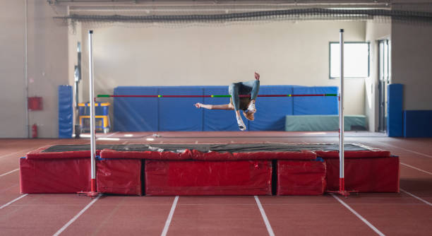 istock Female Athlete High Jumping Over Horizontal Bar 1650857483