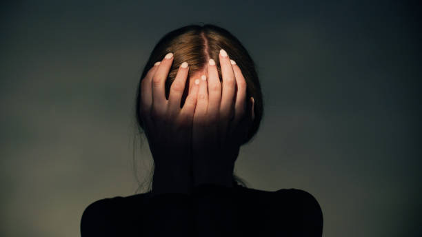 istock Woman covers her face with her hands in round light. Studio shot. 1650858906