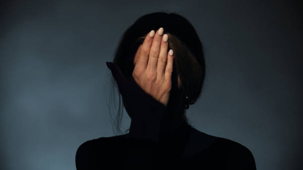istock Woman covers her face with her hands . Studio shot. 1650858940