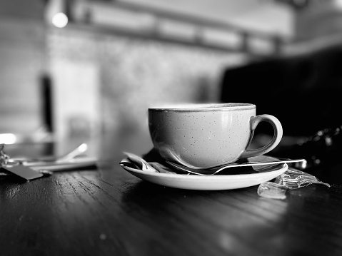 A coffee cup and saucer on a restaurant table