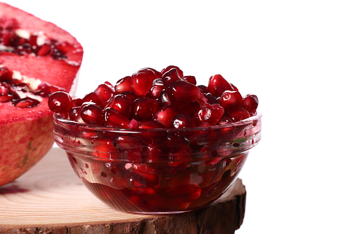 Close-up of pomegranate seeds texture on a white background, top view.  Ripe red garnet fruit