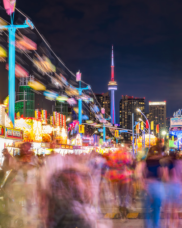 Toronto, Canada - August 29, 2023 :  Crowds and activity at the annual Canadian National Exhibition (CNE) at night
