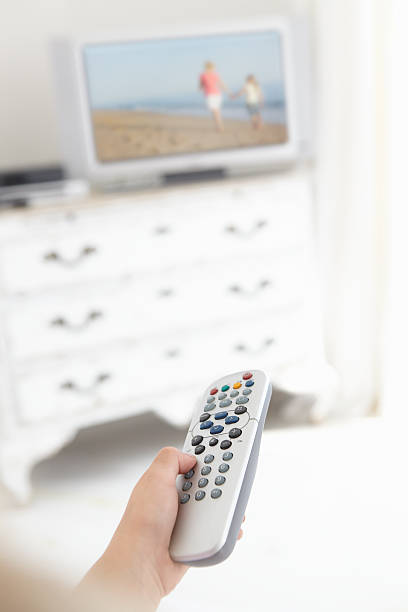istock Young Girl Holding Television Remote Control In Bedroom 165086828
