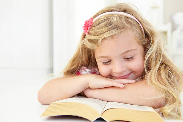 istock Young Girl Reading Book In Bedroom 165086855