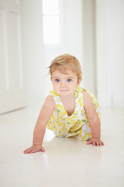 istock Young Girl Crawling On Floor 165086870