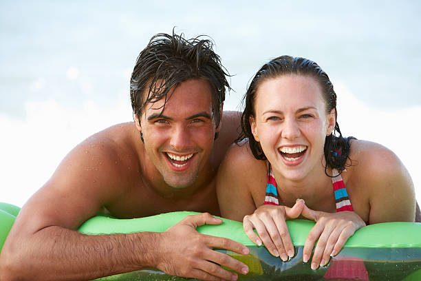 istock Young Couple Having Fun In Sea On Airbed 165086946