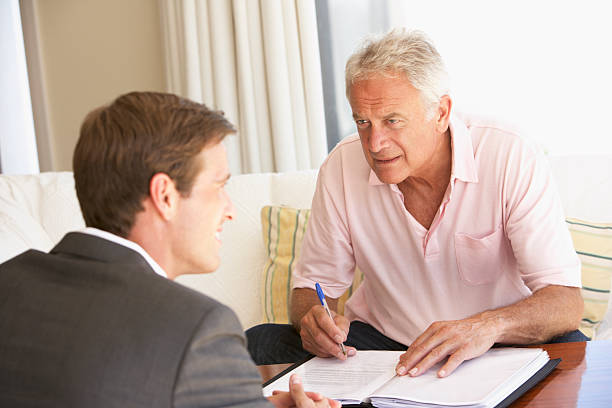 istock Senior Man Meeting With Financial Advisor At Home 165087542