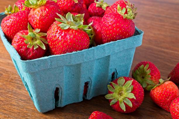 istock Close up quart of strawberries on a rustic wooden table. 1650875800