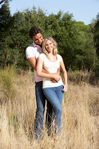 istock Young Couple Standing In Summer Countryside 165087690