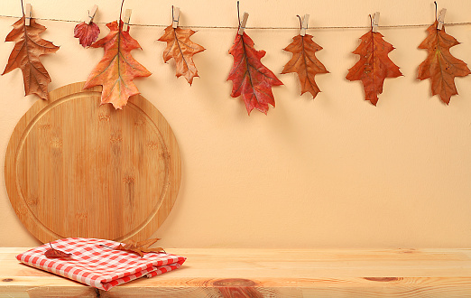 Empty wooden table with kitchen utensils and maple leaves,eco concept,kitchen mockup for design and showcase for product showcase,Creative autumn composition,screen banner. Happy Thanksgiving and greeting card, selective focus