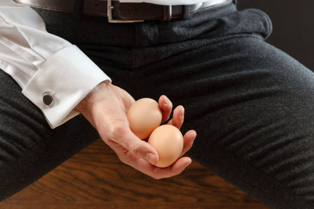 Two eggs in a man's hand.