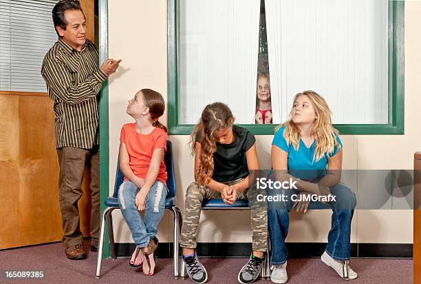 Three Female Students In Trouble And Awaiting The Principal Stock Photo - Download Image Now