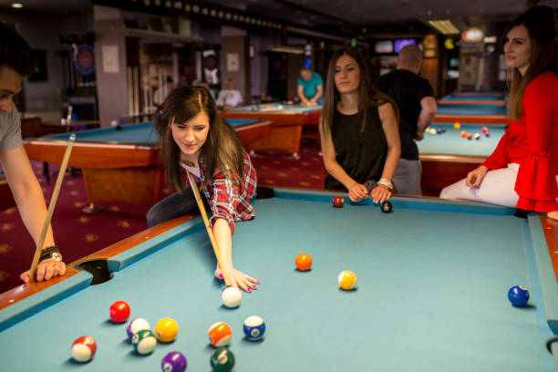 istock Group of friends play billiards 1650895619