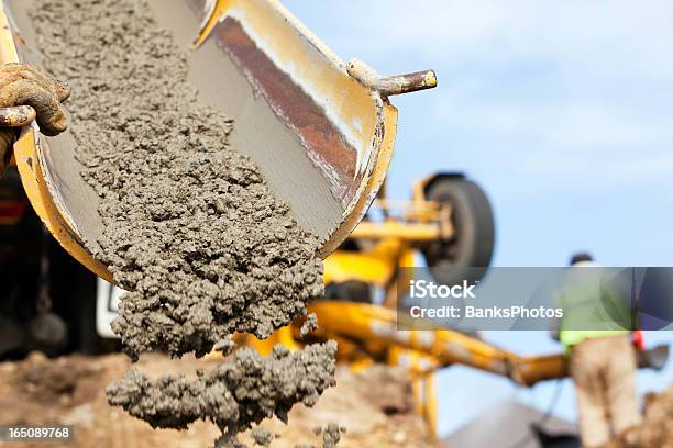 Construction Worker Guiding Cement Mixer Truck Trough Stock Photo - Download Image Now