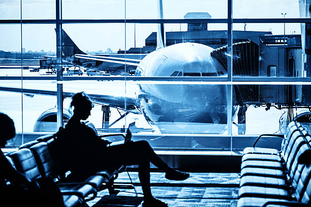 Woman waiting for flight at airport lounge Woman waiting for flight at airport lounge. airports canada stock pictures, royalty-free photos & images