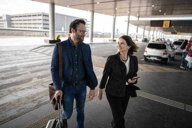 istock Coworkers talking while walk at the airport 1650906197