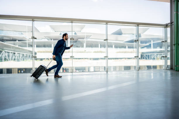 Businessman running while use phone at the airport