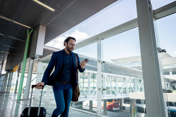 istock Businessman running while use phone at the airport 1650907319