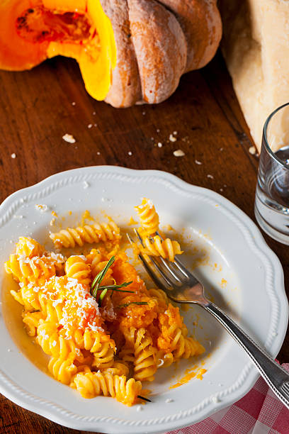 istock Fusilli Pasta with Orange Autumn Pumpkin Sauce and Grated Cheese 165090903
