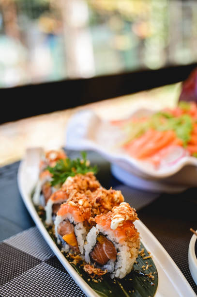 istock fresh raw sushi on a plate in a restaurant. 1650951006
