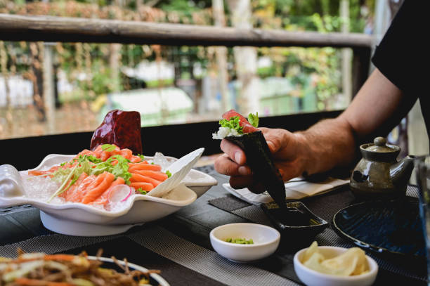 man eating Japanese food at restaurant.