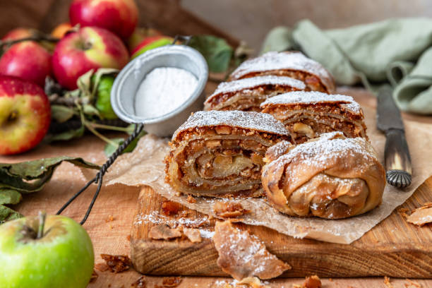 Homemade traditional Apple strudel on a wooden background Homemade traditional Apple strudel on a wooden background apple strudel stock pictures, royalty-free photos & images