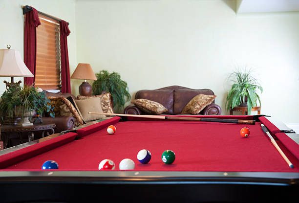 istock Balls  and cues on pool table in game room 165097582