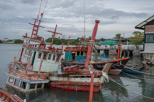 At the fishing pier in the late afternoon the Thai fishing boats from Naklua are lashed to their moorings.\nThe fishermen spend free time on board and live in the cabins of their boats. \nPattaya District Chonburi in Thailand Asia\nAugust 31st 2023