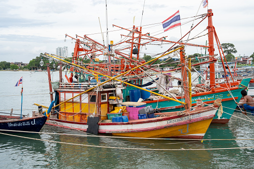 At the fishing pier in the late afternoon the Thai fishing boats from Naklua are lashed to their moorings.
The fishermen spend free time on board and live in the cabins of their boats. 
Pattaya District Chonburi in Thailand Asia
August 31st 2023