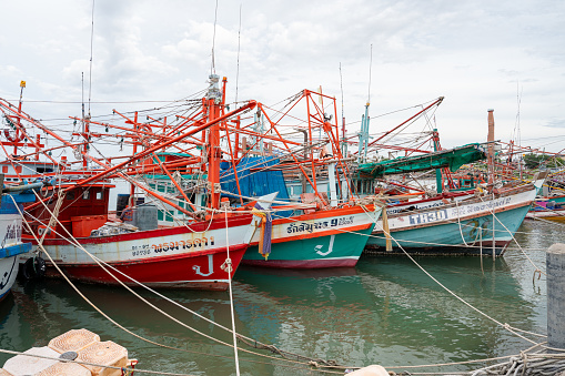 At the fishing pier in the late afternoon the Thai fishing boats from Naklua are lashed to their moorings.\nThe fishermen spend free time on board and live in the cabins of their boats. \nPattaya District Chonburi in Thailand Asia\nAugust 31st 2023