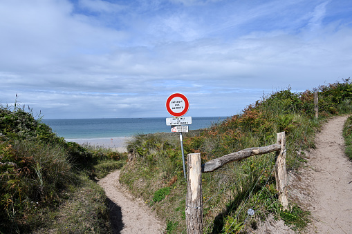 Erquy, France, August 31, 2023 - Beach access to one of the wild beaches in Erquy, the Plage Sauvage du Portuais.