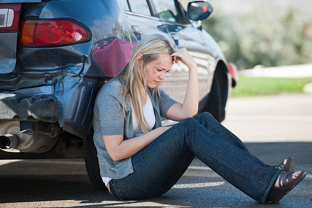 Femal Accident Victim Waits Outside of Her Car stock photo