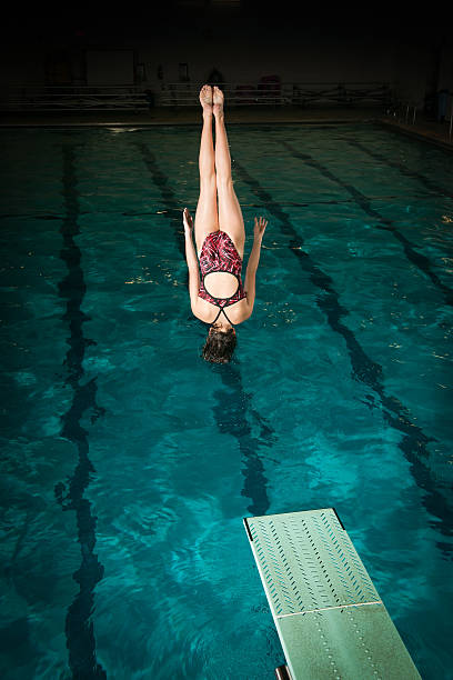 istock Female diver in mid back flip 165103695