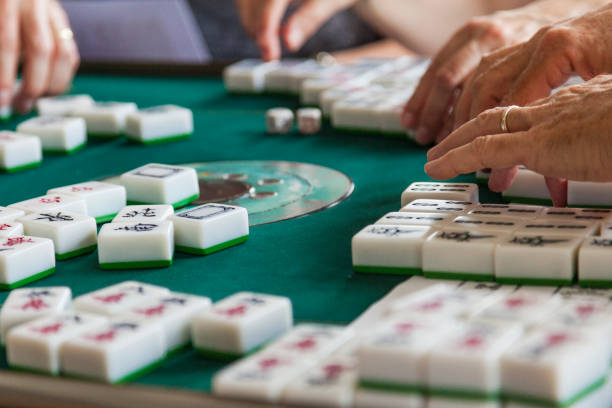 istock Friends Playing a Game of Mahjong 1651038366