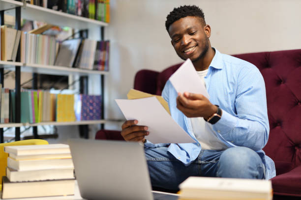istock A focused student in a library, surrounded by books and using a laptop for studying. 1651038898