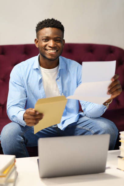 istock A confident businessman reading a financial document on his laptop, working from his home office. 1651038908