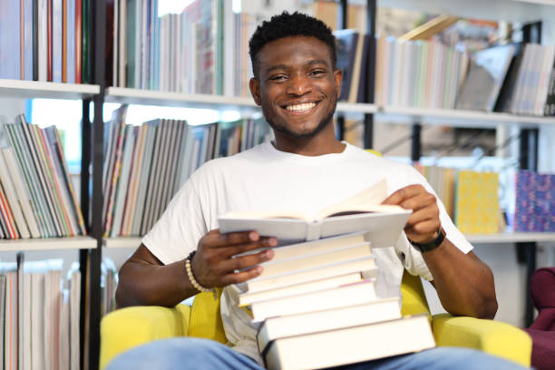 istock A joyful student in a library, immersed in academic pursuits among books and knowledge. 1651038915