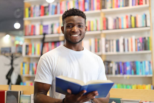 istock A young man immersed in learning at a library, surrounded by books and knowledge. 1651038933