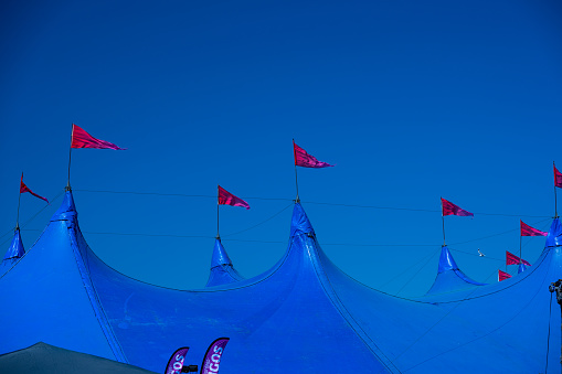 Gothenburg, Sweden - June 03 2023: Large blue festival tent with red flags.