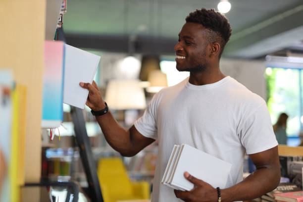 istock A young, happy African American businessman studying, with a thoughtful expression in a modern office. 1651039486