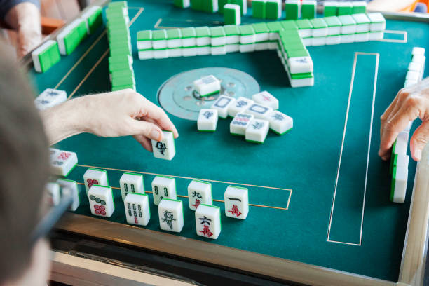 Group of friends playing a game of mahjong.