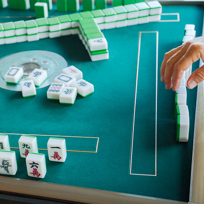 Playing a game of mahjong.