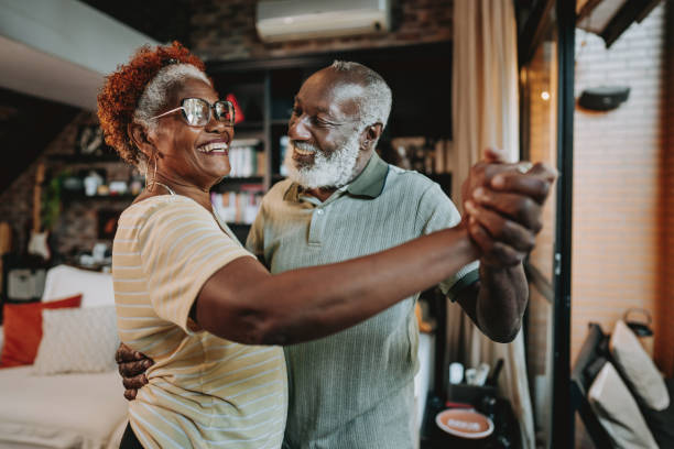 istock Senior couple dancing at home 1651045587