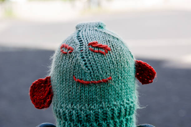 istock Knitted woolen hats on street posts 1651051369
