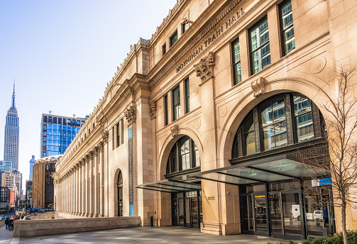 An exterior view of Moynihan Train Hall from the street. The station is an extended part of Penn Station in New York City.